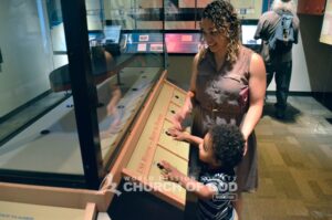 A mommy and her son looking at a ship artifact at The Mariners' Museum.