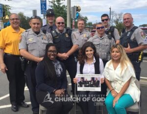 Church of God volunteers and various police departments posing for a photo.